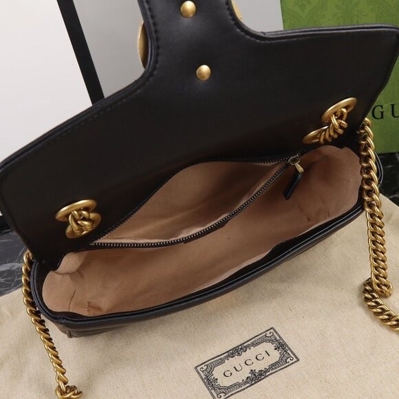 Gucci GG Marmont quilted leather black shoulder bag with gold chain.